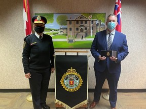 From left, CPS chief of police Shawna Spowart gave deputy chief Vincent Foy his badge after he was sworn in on Jan. 13, 2022. Handout/Cornwall Standard-Freeholder/Postmedia Network