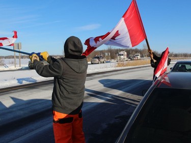 Residents of the Embrun area greeting convoy participants on the Highway 417 westbound off-ramp near Vankleek Hill. Photo on Friday, January 28, 2021, in Vankleek Hill, Ontario.Todd Hambleton/Standard-Freeholder/Postmedia Network
