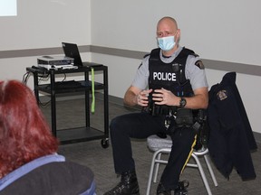 Sgt. Chris Mosley talked with residents at the Devon Community Centre last Wednesday during the monthly Coffee with a Cop session. (Ted Murphy)
