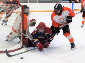 Cochrane Chaos forward Summer Gibbons goes to ground level as she fights to keep the play alive in a 7-1 win over the Calgary Jags at the SLS Family Sports Centre on January 28. Patrick Gibson/Cochrane Times