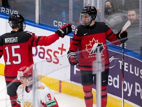 Canada's Connor Bedard (16) celebrates scoring against Russia with Shane Wright (15) during an IIHF World Junior Championship exhibition game in Edmonton on Dec. 23, 2021.