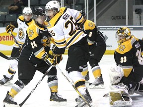 Kingston's Ethan Werek and Sarnia's Garrett Hooey cross sticks in front of Sarnia goaltender John Cullen on Nov. 14, 2010, in Kingston.