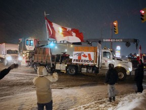 Supporters on Gardiners Road in Kingston wave to trucks that are part of the Convoy for Freedom 2022 as they arrive in the city Thursday, Jan. 27. The convoy is on its way to Ottawa Friday for a rally at Parliament Hill. Elliot Ferguson/The Kingston Whig-Standard