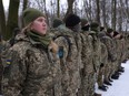 Civilians, including Tatiana, left, 21, a university veterinary medicine student who is also enrolled in a military reserve program, participate in a Kyiv Territorial Defence unit training in a forest on Jan. 22 in Kyiv, Ukraine.
