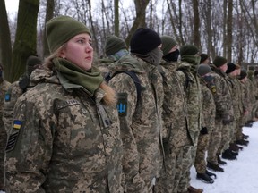 Civilians, including Tatiana, left, 21, a university veterinary medicine student who is also enrolled in a military reserve program, participate in a Kyiv Territorial Defence unit training in a forest on Jan. 22 in Kyiv, Ukraine.