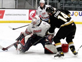 Kingston Frontenacs forward Jordan Frasca gets a shot on Oshawa Generals goaltender Patrick Leaver as defenceman David Jesus moves in to help in Ontario Hockey League action at the Leon's Centre on Friday night.