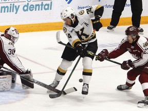 Kingston Frontenacs forward Zayde Wisdom looks for the puck in front of Peterborough Petes goaltender Tye Austin as Petes defenceman James Guo tries to help in Ontario Hockey League action in Peterborough on Thursday night.