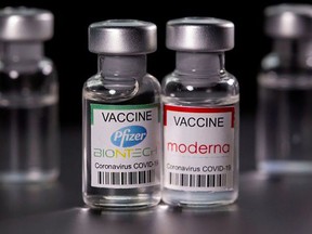 Vials with Pfizer-BioNTech and Moderna coronavirus disease (COVID-19) vaccine labels. (file photo)