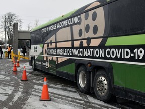 A GO-Vaxx mobile vaccine clinic is making a stop at the Cobden Agricultural Society on Wednesday, Jan. 19. A bus is seen here at a stop near Stratford, Ont. earlier this month.