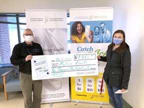 Executive director of the Pembroke Regional Hospital Foundation, Roger Martin presents the Catch the Ace 3.0 week 25 prize winner, Mallory Brooks with her winnings. Submitted photo