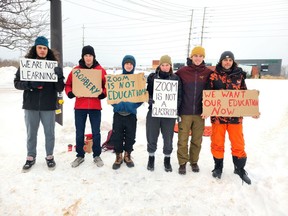 Outdoor Adventure students at Pembroke's Algonquin College are asking the college to return to in-person classes ahead of the planned March 7 date. Taking part in a protest on Lake Street near the college entrance Monday were (from left) Georges Karijian, Nicolas Desmeules, Gryffin Giordano, Annalee Kanwisher, Cailan Robinson and Jack Rawding.