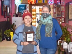 Janna Fortin (right), PBIA board of directors chairwoman, presents the 2021 Best Neighbour award to Nita Polsri, owner of Thai Gardens.