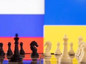 Chess pieces are seen in front of displayed Russia and Ukraine's flags in this illustration taken January 25, 2022. REUTERS/Dado Ruvic/Illustration