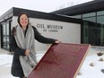 Erin Dee-Richard, curator-supervisor at the Oil Museum of Canada, stands outside the site's main building in Oil Springs. The building recently went through extensive renovations and is set to reopen to the public later this month, if provincial pandemic restrictions end as expected.