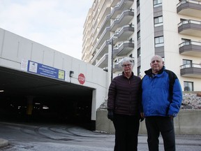 Diane and Jim Lambert stand by the entrance of a parking garage for the Marina Park Place apartment complex off Sandy Lane. The duo are among several apartment complex residents who say they want more security improvements. (Tyler Kula/ The Observer)