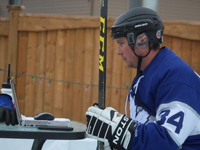 Lambton College professor Justin Randall showed up for a Wednesday virtual class in full hockey gear and with his lap top set up on a patio table on the backyard rink at his home in Corunna.  (PAUL MORDEN, The Observer)