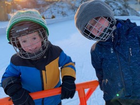 Tejay Randall, 3, and his brother Austan Randall, 5, enjoy the backyard rink their father, Lambton College professor Justin Randall, built at their home in Corunna.  (Handout)