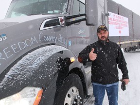 Enrique Klassen, of Leamington, gives a thumbs up before leaving the truck stop at Reece's Corners Sunday morning as part of a protest convoy.