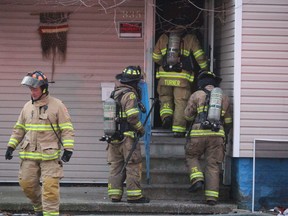 Sarnia firefighters re-enter a home on Davis Street Saturday after putting out a fire. There were no injuries, a fire official said.