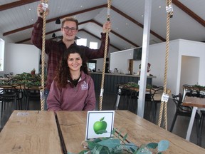Alicia and Garren Hardman are shown with one of the swing tables in the new tasting room at their Shale Ridge Estate Winery near Thedford.