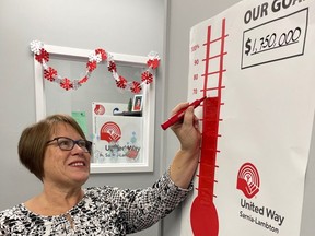 Campaign chairperson Vicky Ducharme updates the United Way of Sarnia-Lambton thermometer.