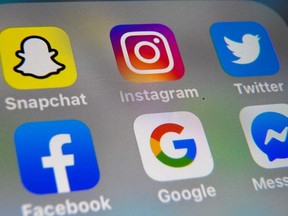 A picture taken in Lille, France shows the logos of mobile apps Instagram, Snapchat, Twitter, Facebook, Google and Messenger displayed on a tablet, Oct. 1, 2019.