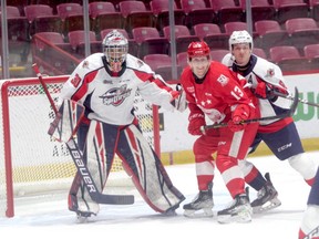 Soo Greyhounds forward Marc Boudreau and Windsor Spitfires defenceman Nathan Ribau get up close and personal with Spits goalie Xavier Medina in OHL action at the GFL Memorial Gardens on Saturday night. The Spitfires picked up a 5-2 win over the Greyhounds.