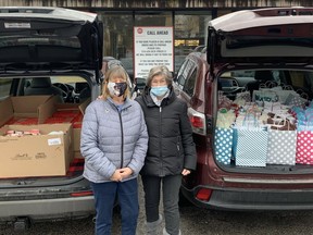 Lynda Simpson (left) and  Bettyann Carty pick up New Year's Eve meals on Friday to deliver to residents at Hambleton Hall, a supervised housing complex operated by Indwell. The Rotary Cub of Norfolk Sunrise also donated gift bags and grocery store gift cards. CONTRIBUTED PHOTO