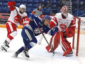 Kocha Delic, middle, of the Sudbury Wolves, chases down the puck during OHL action against the Soo Greyhounds at the Sudbury Community Arena in Sudbury, Ont. on Tuesday January 4, 2022. John Lappa/Sudbury Star/Postmedia Network