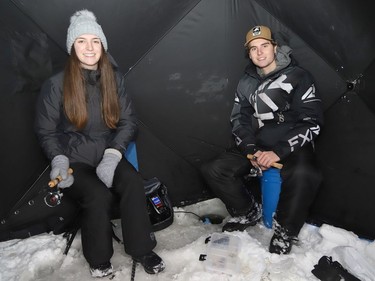 Lianne Godin and her brother, Olivier, fish in their fishing hut at Lake Laurentian in Sudbury, Ont. on Wednesday January 5, 2022. John Lappa/Sudbury Star/Postmedia Network