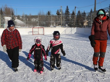 Tessa, second left, and her sister, Leah, learn to skate under the watchful eyes of their mom, Carmen Debruyn, right, and neighbour Renee Lalonde at Diorite Playground in Copper Cliff, Ont. on Friday January 7, 2022. John Lappa/Sudbury Star/Postmedia Network