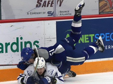 Chase Stillman, top, of the Sudbury Wolves, and Dylan Gordon, of the Mississauga Steelheads, collide during OHL action at the Sudbury Community Arena in Sudbury, Ont. on Friday January 7, 2022. John Lappa/Sudbury Star/Postmedia Network