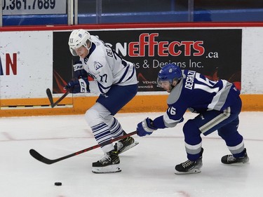 Nick DeGrazia, right, of the Sudbury Wolves, and Ethan Del Mastro, of the Mississauga Steelheads, battle for the puck during OHL action at the Sudbury Community Arena in Sudbury, Ont. on Friday January 7, 2022. John Lappa/Sudbury Star/Postmedia Network
