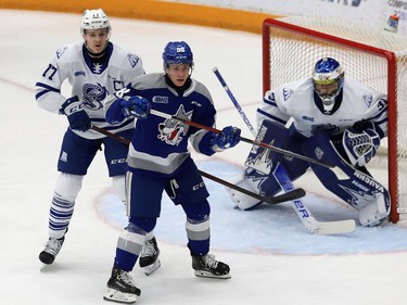 David Goyette, middle, of the Sudbury Wolves, jostles for position with Ethan Del Mastro, of the Mississauga Steelheads, during OHL action at the Sudbury Community Arena in Sudbury, Ont. on Friday January 7, 2022. John Lappa/Sudbury Star/Postmedia Network