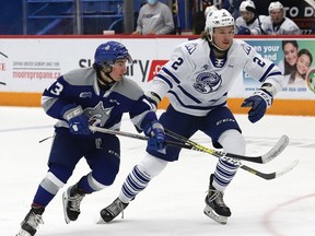 Kocha Delic, left, of the Sudbury Wolves, and Evan Brand, of the Mississauga Steelheads, battle for position during OHL action at the Sudbury Community Arena in Sudbury, Ont. on Friday January 7, 2022. John Lappa/Sudbury Star/Postmedia Network
