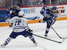 Liam Ross, right, of the Sudbury Wolves, fires the puck past Dylan Gordon, of the Mississauga Steelheads, during OHL action at the Sudbury Community Arena in Sudbury, Ont. on Friday January 7, 2022. John Lappa/Sudbury Star/Postmedia Network