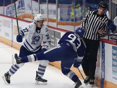 Matthew Mania, right, of the Sudbury Wolves, and Charlie Callaghan, of the Mississauga Steelheads, collide during OHL action at the Sudbury Community Arena in Sudbury, Ont. on Friday January 7, 2022. John Lappa/Sudbury Star/Postmedia Network