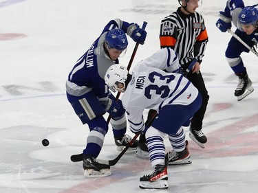 Landon McCallum, left, of the Sudbury Wolves, and Luke Misa, of the Mississauga Steelheads, take part in a faceoff during OHL action at the Sudbury Community Arena in Sudbury, Ont. on Friday January 7, 2022. John Lappa/Sudbury Star/Postmedia Network