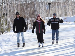 Matt Verreault, left, Vivianna Corkill and Andrew Girard braved the frigid temperatures and went skating at Nina's Way ice skating trail at Kivi Park in Sudbury, Ont. on Friday January 14, 2022. John Lappa/Sudbury Star/Postmedia Network