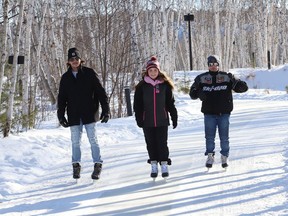 Matt Verreault, left, Vivianna Corkill and Andrew Girard braved the frigid temperatures and went skating at Nina's Way ice skating trail at Kivi Park in Sudbury. John Lappa/Sudbury Star/Postmedia Network