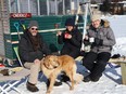 Dave Battaino, left, and his wife, Kate Barber and brother-in-law, Michael Barber, enjoy chili while admiring the scenery with Rosseau the dog on Ramsey Lake in Sudbury, Ont. on Tuesday January 18, 2022. John Lappa/Sudbury Star/Postmedia Network