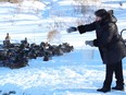 Marilyn Orford feeds a group of ducks at Fielding Memorial Park in Greater Sudbury, Ont. on Thursday January 20, 2022. John Lappa/Sudbury Star/Postmedia Network
