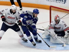 David Goyette, middle, of the Sudbury Wolves, looks for a rebound in front of goalie Zachary Paputsakis, of the Oshawa Generals, during OHL action at the Sudbury Community Arena in Sudbury, Ont. on Friday January 21, 2022. John Lappa/Sudbury Star/Postmedia Network
