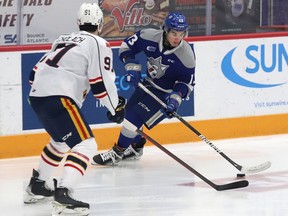 Kocha Delic, right, of the Sudbury Wolves, attempts to elude Artur Cholach, of the Barrie Colts, during OHL action at the Sudbury Community Arena in Sudbury, Ont. on Tuesday January 25, 2022. John Lappa/Sudbury Star/Postmedia Network