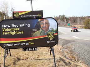 A billboard advertising for volunteer firefighters sits on the location of  the Beaver Lake Welcome Centre on March 30, 2021.