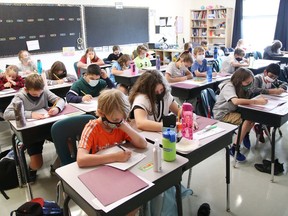 Grade 5 students take part in a class lesson at MacLeod Public School in Sudbury, Ont., during the first day back to school on Tuesday September 7, 2021. A sources says school will resume Jan. 17 in Ontario. John Lappa/Sudbury Star/Postmedia Network