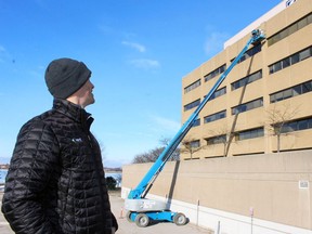 Gabriel Proulx, Kent's vice-president of operations in Canada, watches the letters for the company's former name come down from the St. Clair Corporate Centre on on Jan. 15. Terry Bridge/Postmedia