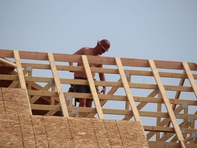 A construction worker is shown on the job at a new home under construction on Kamal Drive in Sarnia in August 2021. Paul Morden/Postmedia