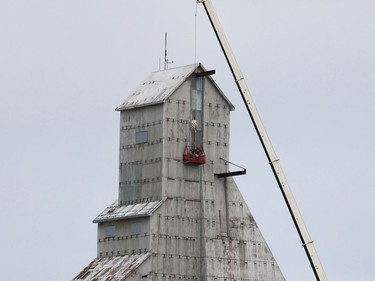 A pair of workers involved with the restoration of the McIntyre headframe are seen on a suspended platform at the top of the iconic landmark in this photo that was taken in mid-November. City council was advised that during the course those renovations, the contractor, Cy Rheault Construction, and staff from the City of Timmins overseeing the project identified a number of deficiencies requiring additional costs for the restoration.

ANDREW AUTIO/The Daily Press
