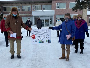 Tom Shura (left) and Susan Norton display a sign announcing Shura’s sizeable donation to Pinecrest Home Auxiliary Jan.12. Due to Covid restrictions the presention was held on the Pinecrest Home grounds. Note participants all six feet apart and masked.